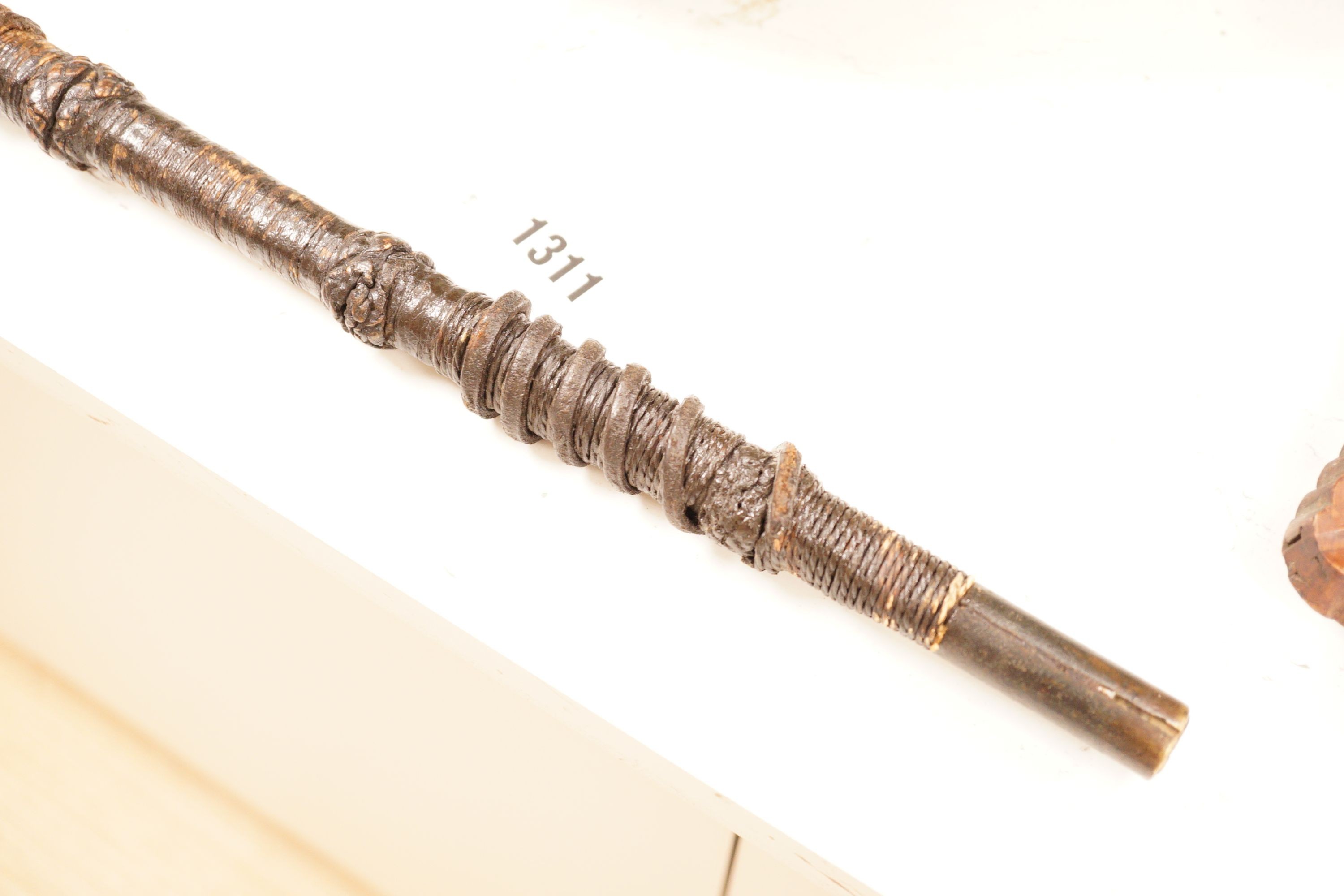 A ceremonial sword stick with removable brush end